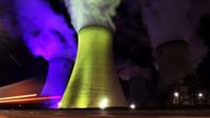 A car drives past the Drax Power Station, illuminated in the colours of the Ukrainian flag, in North Yorkshire, Britain April 1, 2022. Picture taken April 1, 2022 and with a slow shutter speed. REUTERS/Lee Smith
