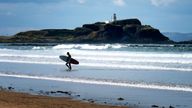 A surfer comes out the water on Yellowcraig Beach near North Berwick, East Lothian, as more hot weather is due to hit the UK this week. PRESS ASSOCIATION Photo. Picture date: Tuesday July 16, 2019. See PA story WEATHER Hot. Photo credit should read: Jane Barlow/PA Wire