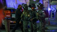 Israeli forces stand guard near the scene of the shooting