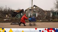 Anna, 78, transports food that volunteers have given her, on her late son&#39;s baby pram, in front of destroyed houses at a village, amid Russia&#39;s invasion of Ukraine, near Kherson, Ukraine January 31, 2023. REUTERS/Nacho Doce