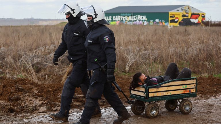 Police officers take away an activist on a trolley during a sit-in protest against the expansion of the Garzweiler open-cast lignite mine of Germany&#39;s utility RWE, in Luetzerath, Germany, January 11, 2023 that has highlighted tensions over Germany&#39;s climate policy during an energy crisis. REUTERS/Wolfgang Rattay TPX IMAGES OF THE DAY

