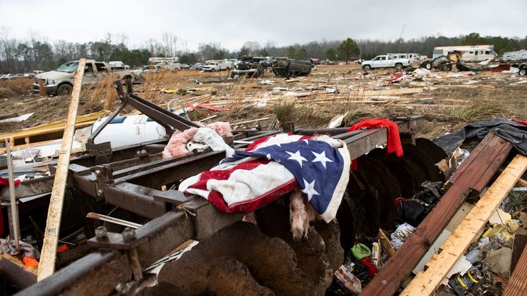 A flag hangs from the remains of a tornado-damaged home on County Road 140 in Old Kingston, Alabama, U.S., Jan. 13, 2023.  Jake Crandall/USA TODAY Network, Reuters Resale prohibited. There is no file.mandatory credit