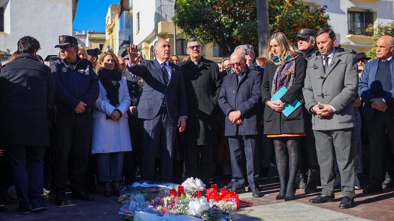 People gather for a minute of silence for the church sacristan killed in the attack