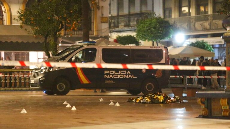 Medical and police officers cover the body of the sacristan killed in an attack in Algeciras, Cadiz