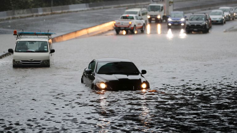Vehicles are stranded by floodwaters in Oakland, Saturday, January 28, 2023. Record rainfall has hit New Zealand's largest city, causing widespread damage.  (Dean Purcell/New Zealand Herald, AP)