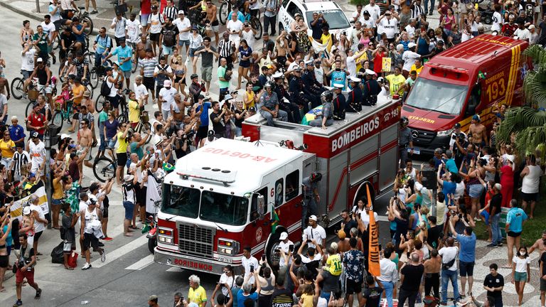 General view of fans as the casket of Brazilian soccer legend Pele is transported by the fire department, from his former club Santos&#39; Vila Belmiro stadium 