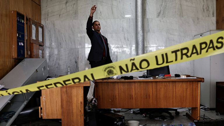 A person inspects the damage, after the supporters of Brazil&#39;s former President Jair Bolsonaro protests  at Planalto Palace, in Brasilia, Brazil