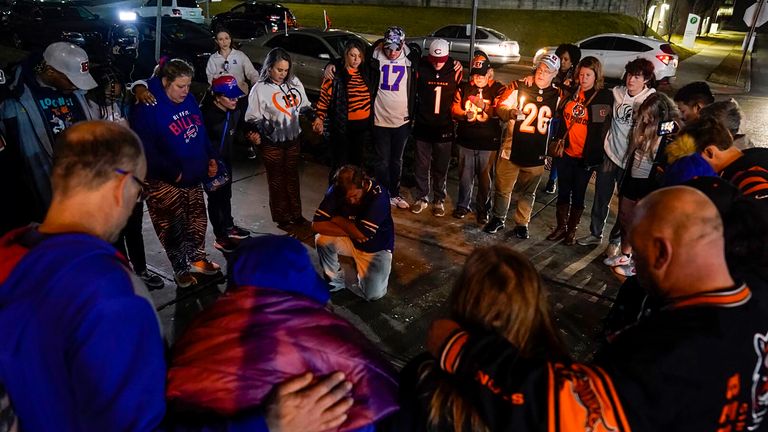 Fans gather outside of University of Cincinnati Medical Center, late Monday, Jan. 2, 2023, in Cincinnati, where Buffalo Bills&#39; Damar Hamlin was taken after collapsing on the field during an NFL football game against the Cincinnati Bengals. (AP Photo/Jeff Dean)