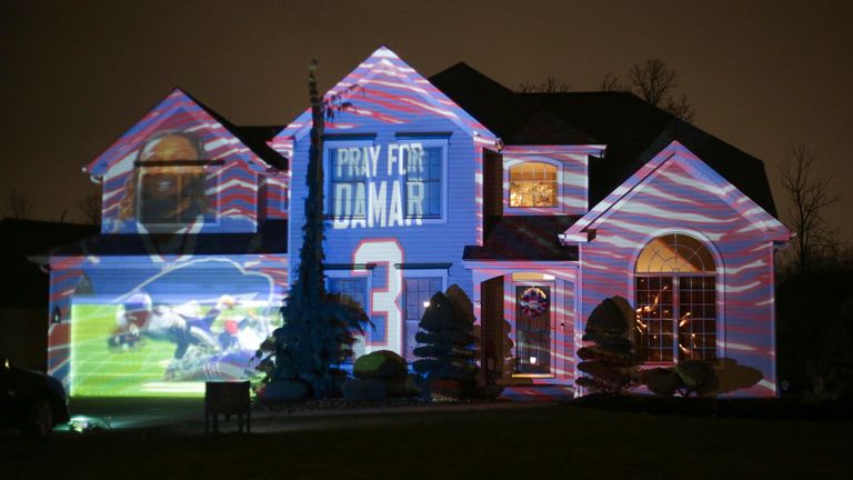 A projection showing support for Buffalo Bills safety Damar Hamlin is seen on Michael and Shauna Karas&#39; house Friday, Jan. 6, 2023, in Lancaster, N.Y. Hamlin is now breathing and walking on his own, and traded in the writing pad he had been using to communicate. (AP Photo/Joshua Bessex)