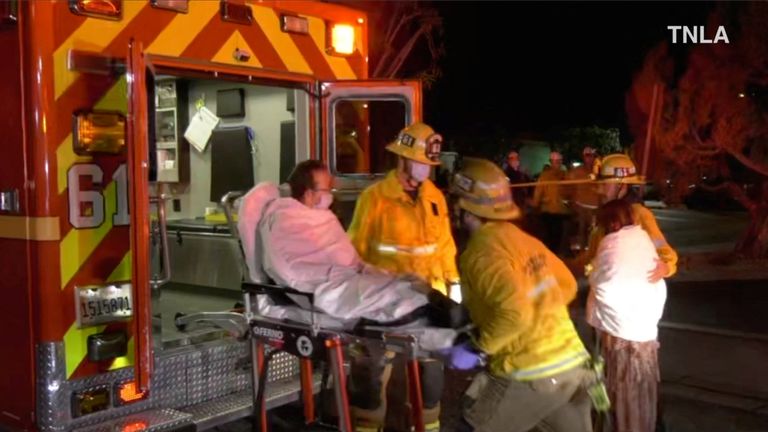 A screen capture from a video shows emergency personnel assisting a person into an ambulance after a shooting in Monterey Park, California, U.S., January 22, 2023. TNLA/Handout from Reuters