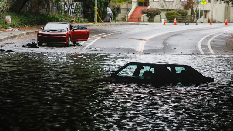 The car was stuck in a flooded underpass on Webster Street. and 34th Street have been flooded since this weekend's storm in Oakland, California, Wednesday, January 4, 2023.  (Salgu Wissmath/San Francisco Chronicle via AP)