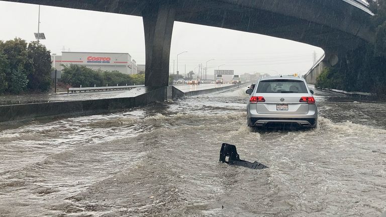 Traffic drives through flooded lanes on Highway 101 in South San Francisco, California, Saturday, Dec. 31, 2022. A flood watch is in effect across much of Northern California through New Year&#39;s Eve. Officials warned that rivers and streams could overflow and urged residents to get sandbags ready. (AP Photo/Jeff Chiu)