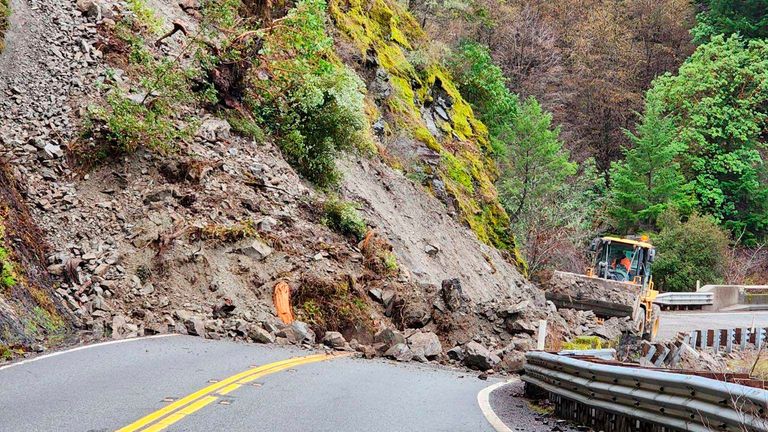 This photo provided by Micah Crockett, Weaverville Maintenance Supervisor of District 2, shows heavy machinery moving a rock slide on State Route 299, in Trinity County, between Burnt Ranch and Hawkins Bar in Burnt Ranch, California, Saturday, December 31, 2022. 