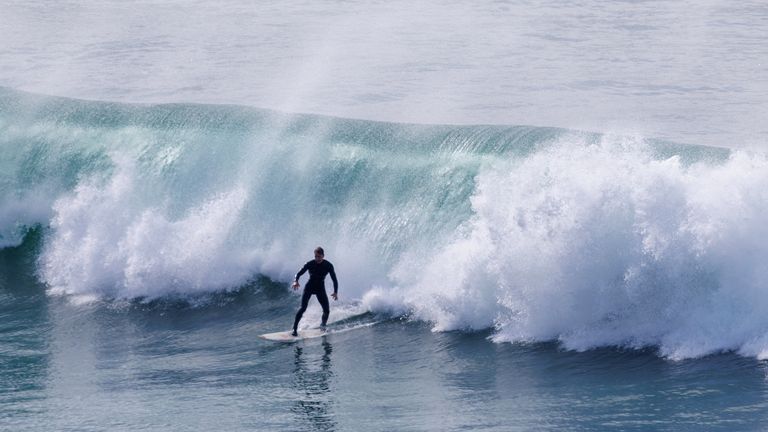 Big waves have brought out the Golden State's surfers despite the danger 