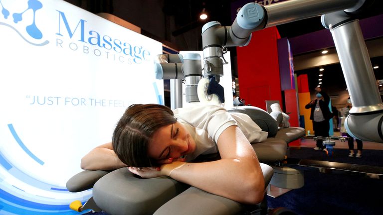 Kirsten Mackin gets a massage at the Massage Robotics booth during CES 2022 at the Las Vegas Convention Center in Las Vegas, Nevada, U.S. January 6, 2022. REUTERS/Steve Marcus TPX IMAGES OF THE DAY