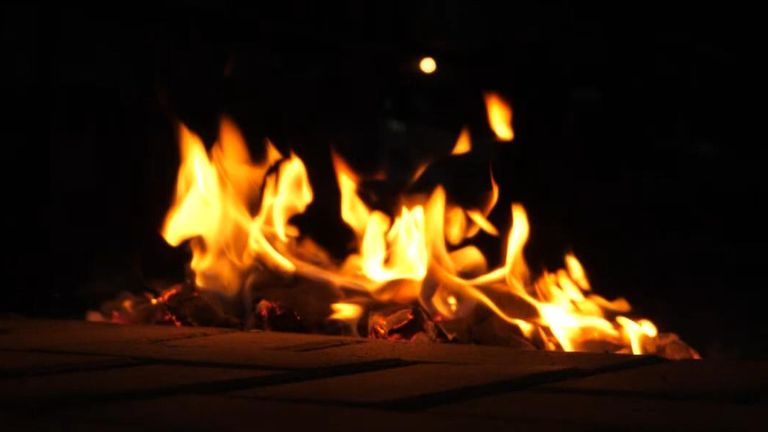 People burned paper money in the street to honor the dead on New Year's Eve