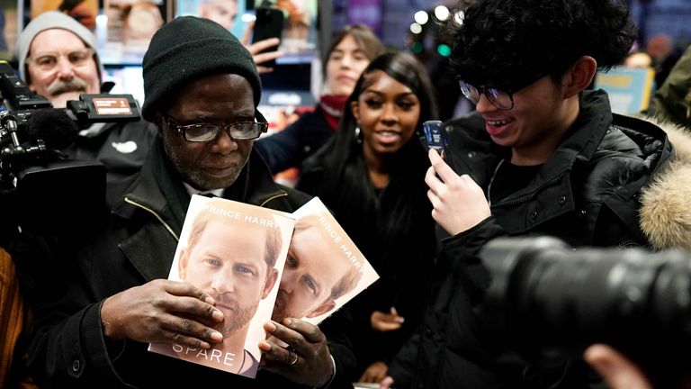 Media photograph a customer at WH Smiths in Victoria Station in London, as they make a purchase of three copies of Spare, the newly released autobiography from the Duke of Sussex, which became available from midnight. Picture date: Monday January 9, 2023.
