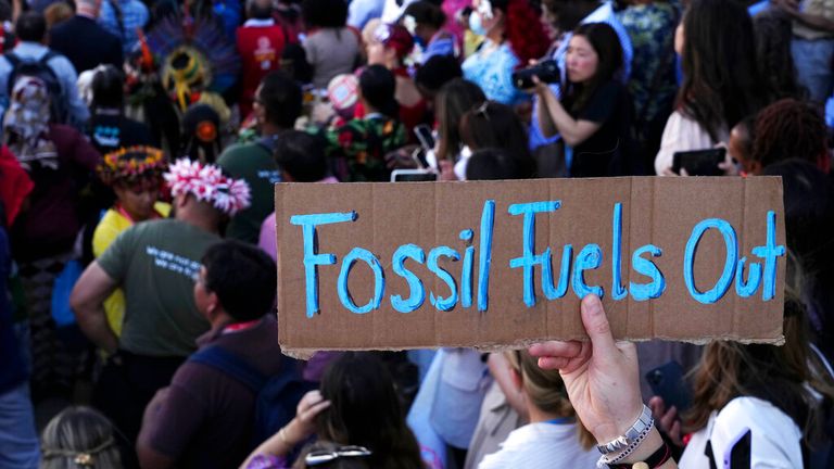 A sign reading "fossil fuels out" is displayed during a demonstration at the COP27 U.N. Climate Summit, Saturday, Nov. 12, 2022, in Sharm el-Sheikh, Egypt. Pic: AP