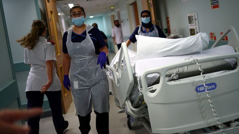 Medical staff transfer a patient through a corridor at The Royal Blackburn Teaching Hospital in East Lancashire, following the outbreak of the coronavirus disease (COVID-19), in Blackburn, Britain, May 14, 2020. Picture taken May 14, 2020. REUTERS/Hannah McKay/Pool