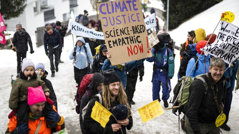 People attend a climate protest rally by Swiss party &#39;Juso&#39; and the organization &#39;Strike WEF&#39; on the eve of the 52nd annual meeting of the World Economic Forum (WEF) in Davos, Switzerland, Sunday, January 15, 2023. The meeting brings together entrepreneurs, scientists, corporate and political leaders in Davos under the topic &#39;Cooperation in a Fragmented World&#39; from 16 to 20 January. (Gian Ehrenzeller/Keystone via AP)