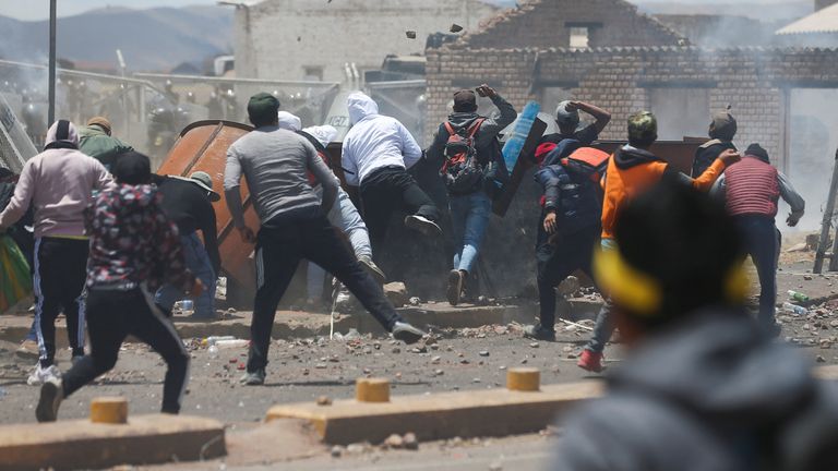 Demonstrators clash with security forces during a protest demanding early elections and the release of jailed former President Pedro Castillo, near the Juliaca airport, in Juliaca, Peru  