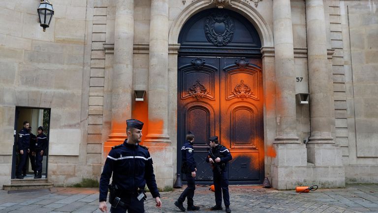 French gendarmes stand in front of the Hotel Matignon after environmental activists of "Derniere Renovation" (Last Renovation) group sprayed paint on the facade to draw attention to climate change and to denounce the French State failure to not honor its climate commitments, in Paris, France, January 4, 2023. REUTERS/Gonzalo Fuentes
