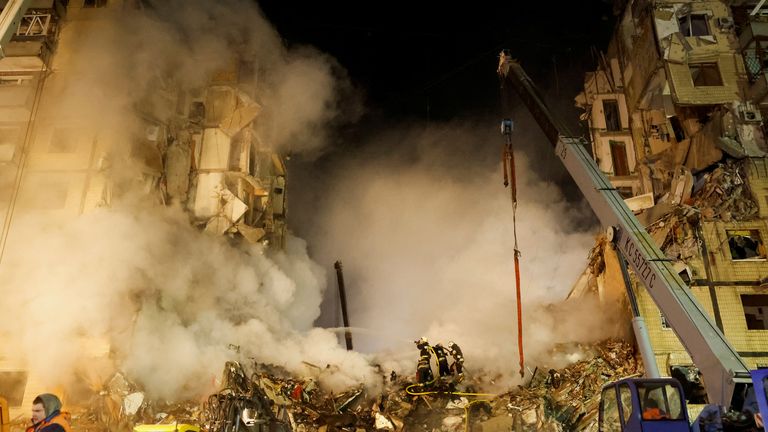 Emergency personnel work at the site where an apartment block was heavily damaged by a Russian missile strike, amid Russia&#39;s attack on Ukraine, in Dnipro, Ukraine January 15, 2023. REUTERS/Clodagh Kilcoyne