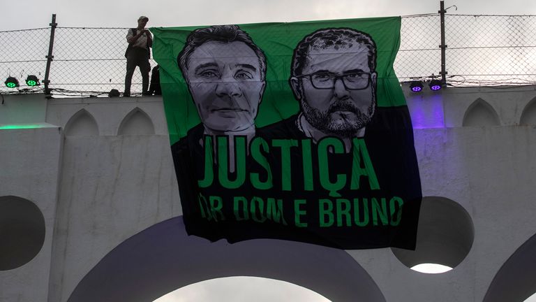 A sign that reads in Portuguese "Justice for Dom and Bruno" and with images of the British journalist Dom Phillips, on the left, and the indigenous specialist Bruno Pereira is displayed on the Arcos da Lapa aqueduct during a protest by environmental groups in Rio de Janeiro, Brazil, June 26, 2022. Brazilian police said Monday, Jan. 23, 2023, they planned to indict Ruben Dario da Silva Villar, a Colombian fish trader, as the mastermind of murders. (AP Photo/Bruna Prado, File)