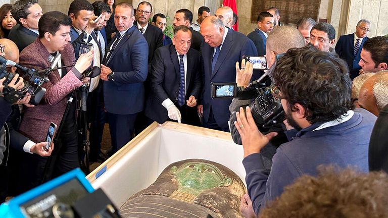 Foreign Minister Sameh Shoukry, center right, and Mostafa Waziri, top official at the Supreme Council of Antiquities, talk in front of an ancient wooden sarcophagus during a handover ceremony at the foreign ministry in Cairo, Egypt, Monday, Jan. 2, 2023