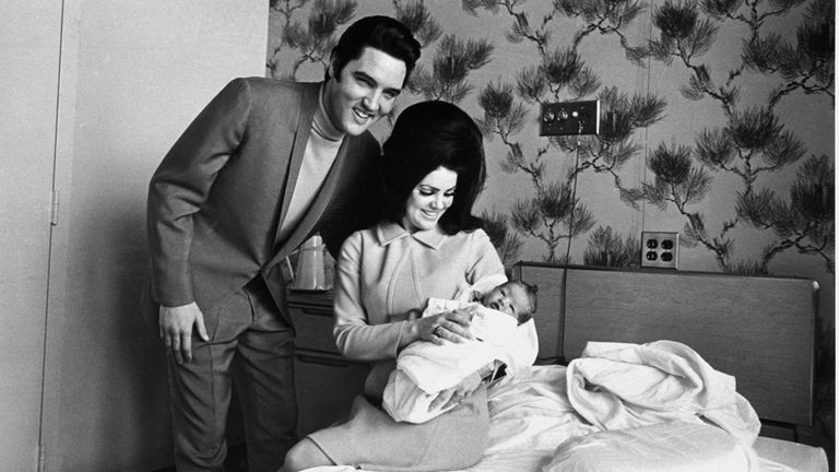 Lisa Marie Presley poses for her first picture, safe in the lap of her mother, Priscilla, on February 5, 1968, while proud father, Elvis Presley, beams his approval. The baby is the first child for Elvis and his wife, the former Priscilla Beaulieu. (AP Photo/Perry Aycock)