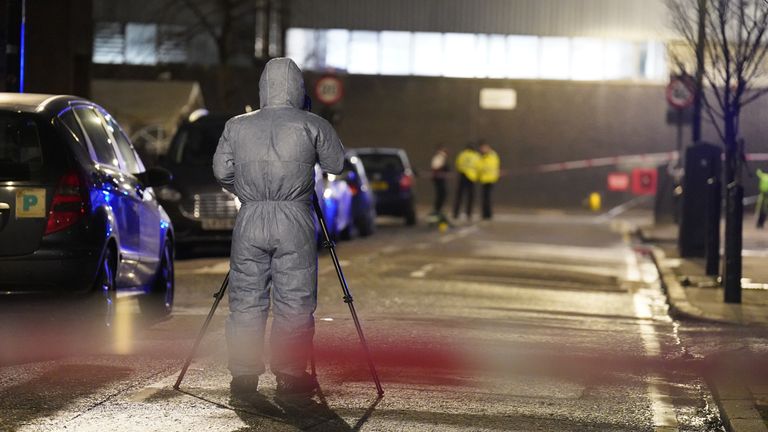 A police forensic officer works at the scene of a suspected drive-by shooting in Phoenix Road, next to Euston station in north London, where three women, aged 48, 54 and 41 along with a seven-year-old girl have been injured near a church where a funeral was taking place. Picture date: Saturday January 14, 2023.