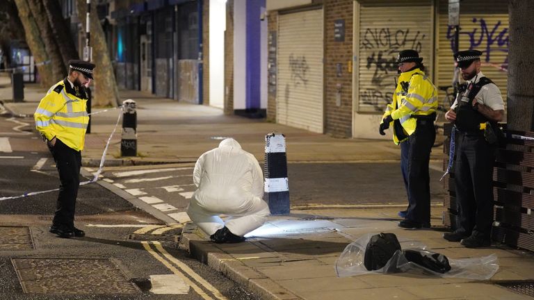 A police forensics officer works near to the scene of a suspected drive-by shooting in Phoenix Road, next to Euston station in north London, where three women, aged 48, 54 and 41 along with a seven-year-old girl have been injured near a church where a funeral was taking place. Picture date: Saturday January 14, 2023.
