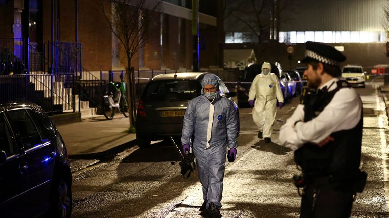 Forensics officers work at the scene the shooting