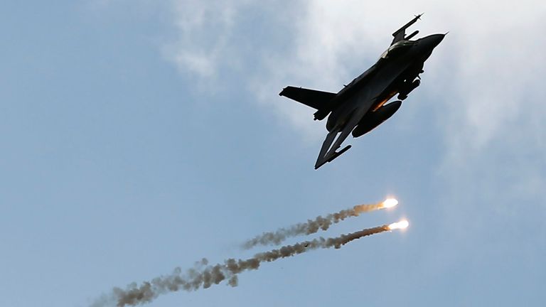 An F-16 jet drops flares in the meantime. "Noble Sword-14" NATO's International Tactical Exercise at the Ground Forces Training Center in Oleszno, near Drasko Pomorski, northwestern Poland, on September 9, 2014.  About 1,700 soldiers from Croatia, Estonia, France, the Netherlands, Lithuania, Germany, Norway, Poland, Slovakia, Slovenia,  The US, Turkey, Hungary, UK and Italy are participating in the three-week exercise.  REUTERS/Kacper Pempel (Poland - Tags: Politics Military)