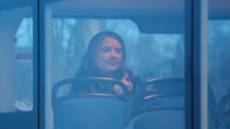 Climate activist Greta Thunberg gestures as she sits in a bus on the day of a protest against the expansion of the Garzweiler open-cast lignite mine of Germany&#39;s utility RWE to Luetzerath