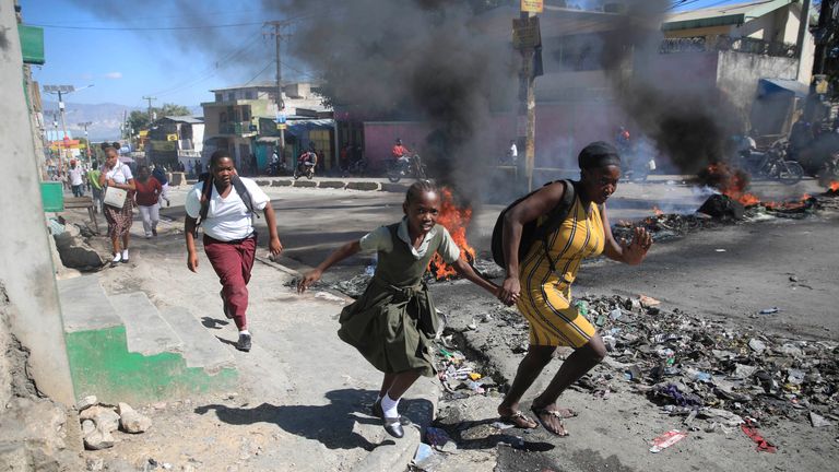Rioting police seize streets in protest after 10 officers killed by Haitian gangs