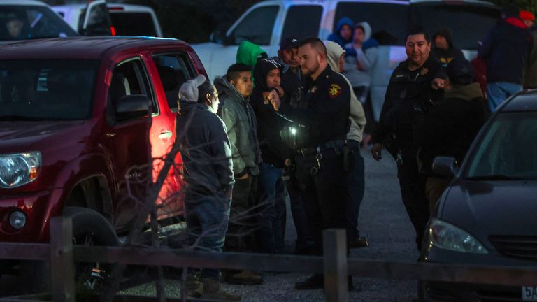 A sheriff's deputy talks to a man after a deadly shooting near Interstate 92 in Half Moon Bay, Calif. Photo: San Francisco Chronicle/AP