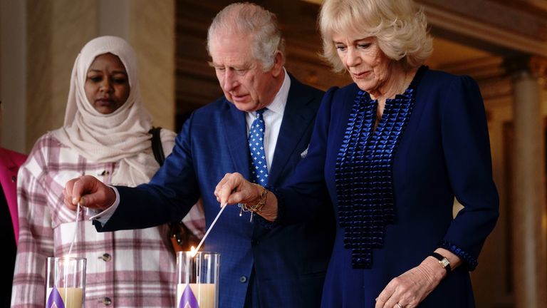 King Charles III and the Queen Consort light a candle at Buckingham Palace, London, to mark Holocaust Memorial Day, alongside Amouna Adam, a survivor of the Darfur genocide, and Holocaust survivor Dr Martin Stern (not pictured). Picture date: Friday January 27, 2023.