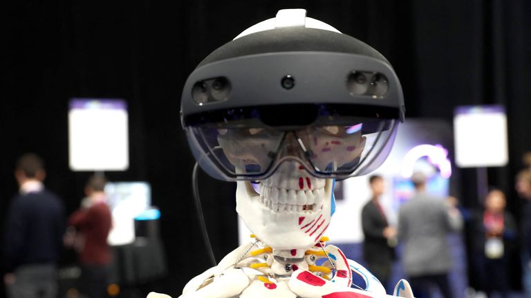 Skeleton with Microsoft HoloLens 2 draws attention to the booth of Abys Medical, the designer of the platform that allows holographic assistance for surgeons during surgery, during the CES unveiling press conference at CES 2023 is an annual consumer electronics trade show held in Las Vegas, Nevada, USA, on January 3, 2023. REUTERS/Steve Marcus