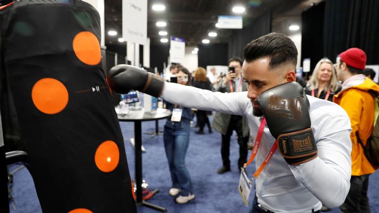 Dan Ngyen Gia hits a heavy bag with an I-Percut smart punching bag cover that sends information to a smartphone during the CES Unveiled press event at CES 2023, an annual consumer electronics trade show, in Las Vegas, Nevada, U.S. January 3, 2023. REUTERS/Steve Marcus
