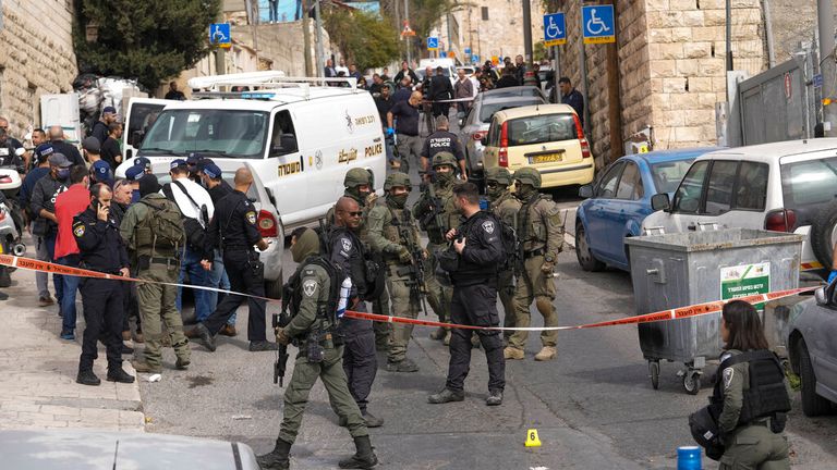 An Israeli policeman secures the scene after the 13-year-old boy fire. Pic: AP