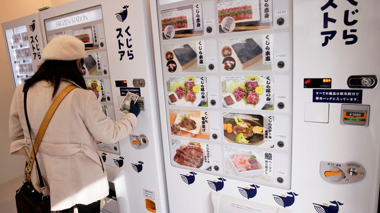 A customer buys whale meat on the opening day of the shop by a Japanese whale-hunting company with vending machines, in Yokohama, Japan, January 24, 2023. REUTERS/Androniki Christodoulou
