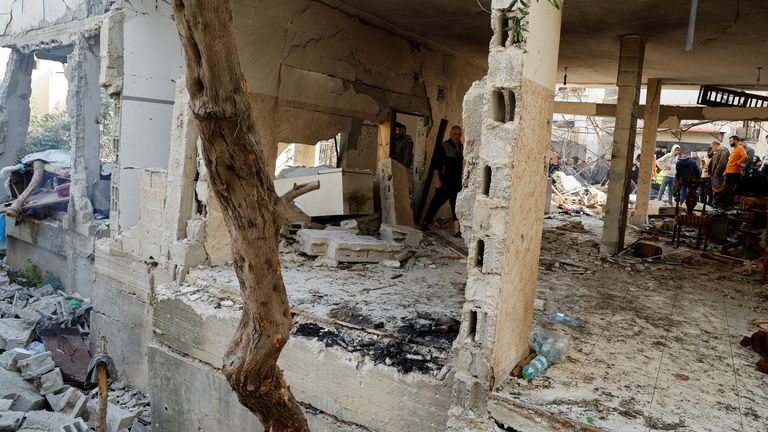 Palestinians inspect a damaged house following an Israeli raid in Jenin in the Israeli-occupied West Bank January 26, 2023. REUTERS/Raneen Sawafta