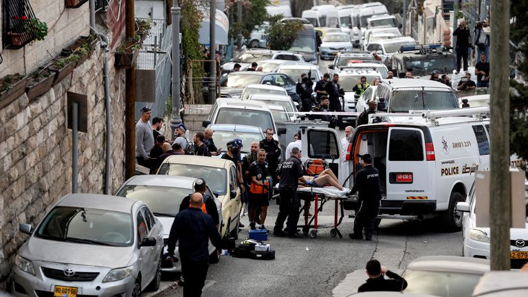 A person is wheeled on a stretcher at a scene where a suspected incident of shooting attack took place, police spokesman said, just outside Jerusalem&#39;s Old City January 28, 2023. REUTERS/Ammar Awad