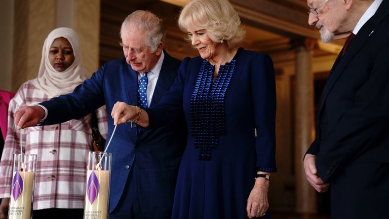 King Charles III and the Queen Consort light a candle at Buckingham Palace, London, to mark Holocaust Memorial Day, alongside Holocaust survivor Dr Martin Stern and a survivor of the Darfur genocide, Amouna Adam. Picture date: Friday January 27, 2023.