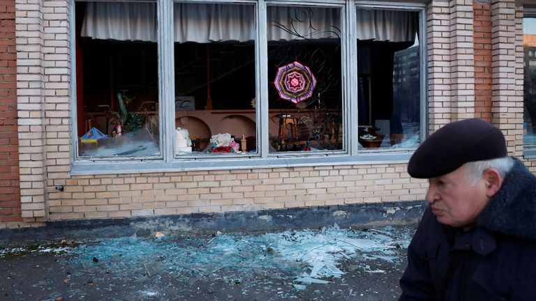 A man walks in front of a damaged building in Kramatorsk