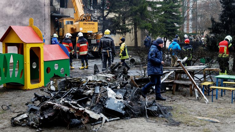 Emergency personnel work at the site of a helicopter crash, in the town of Brovary, outside Kyiv, Ukraine, January 18, 2023. REUTERS/Valentyn Ogirenko ..