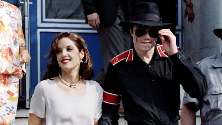 Popstar Michael Jackson and his bride Lisa Marie Presley-Jackson hold each others hands August 6