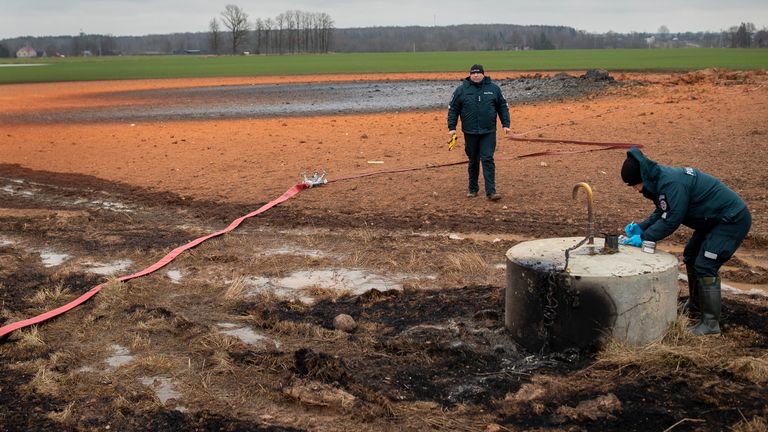 Employees work at the site of the damaged pipeline near Valakeliai village. Pic: AP