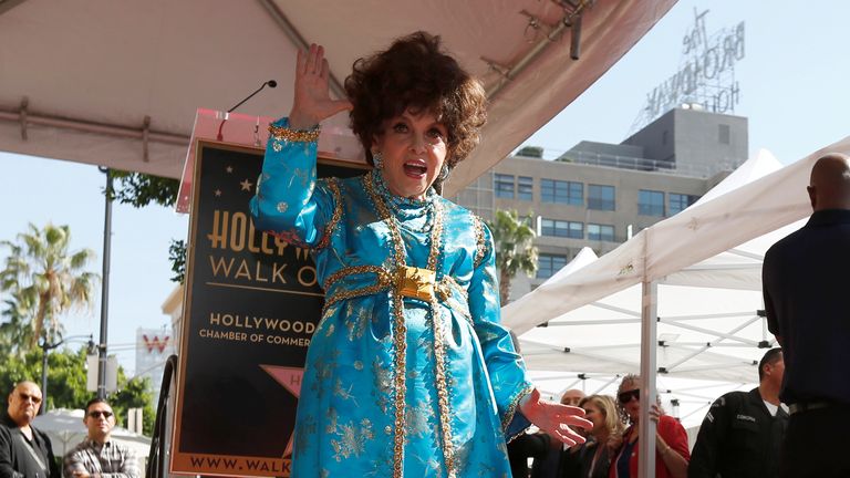 Italian actor Lollobrigida poses on her star after it was unveiled on the Hollywood Walk of Fame in Los Angeles